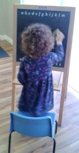 Photograph of child working at blackboard